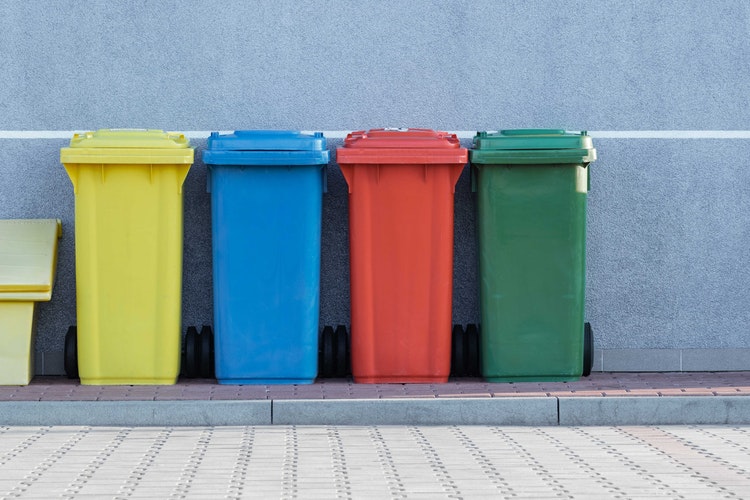 yellow, blue, red, and green bins for waste, recycling and composting trash 